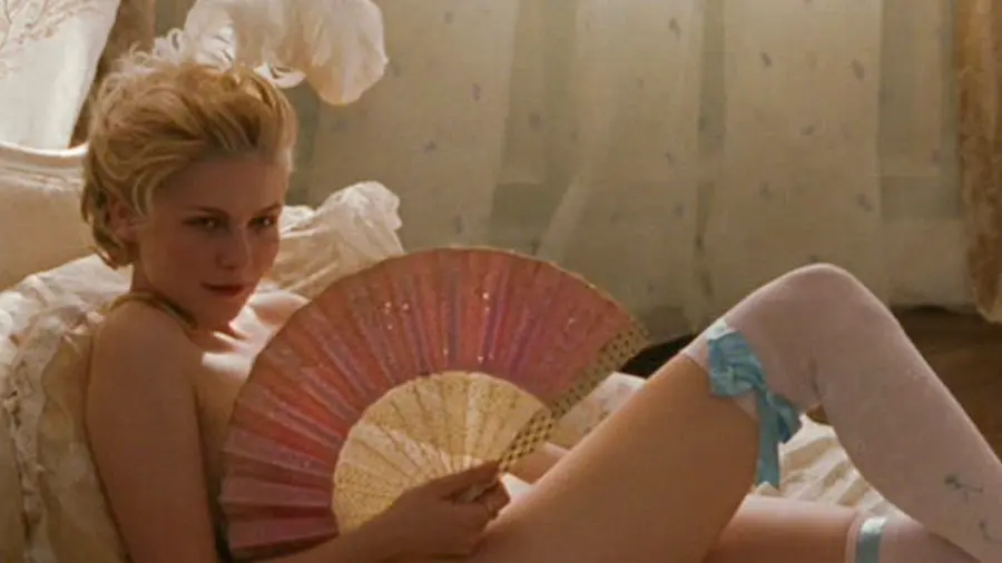 Kirsten Dunst as Marie Antoinette with a pink fan