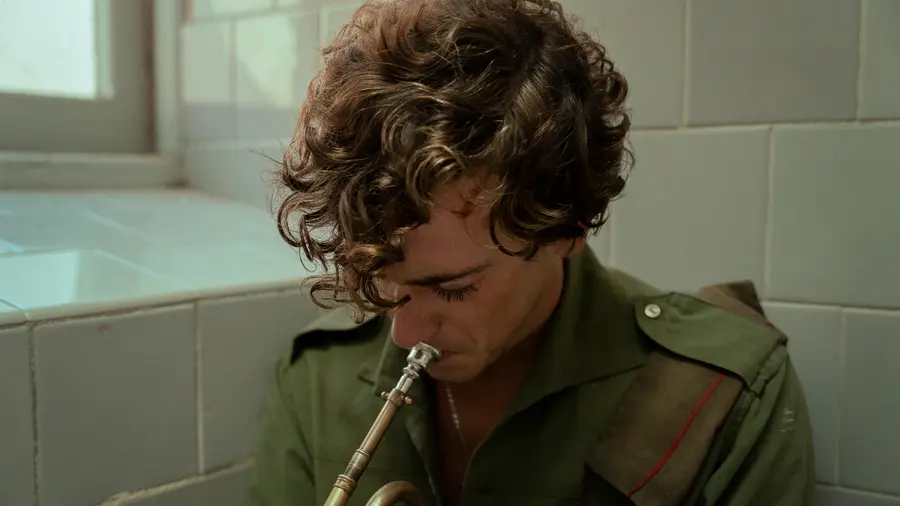 La Bola Negra still: young man playing a wind instrument